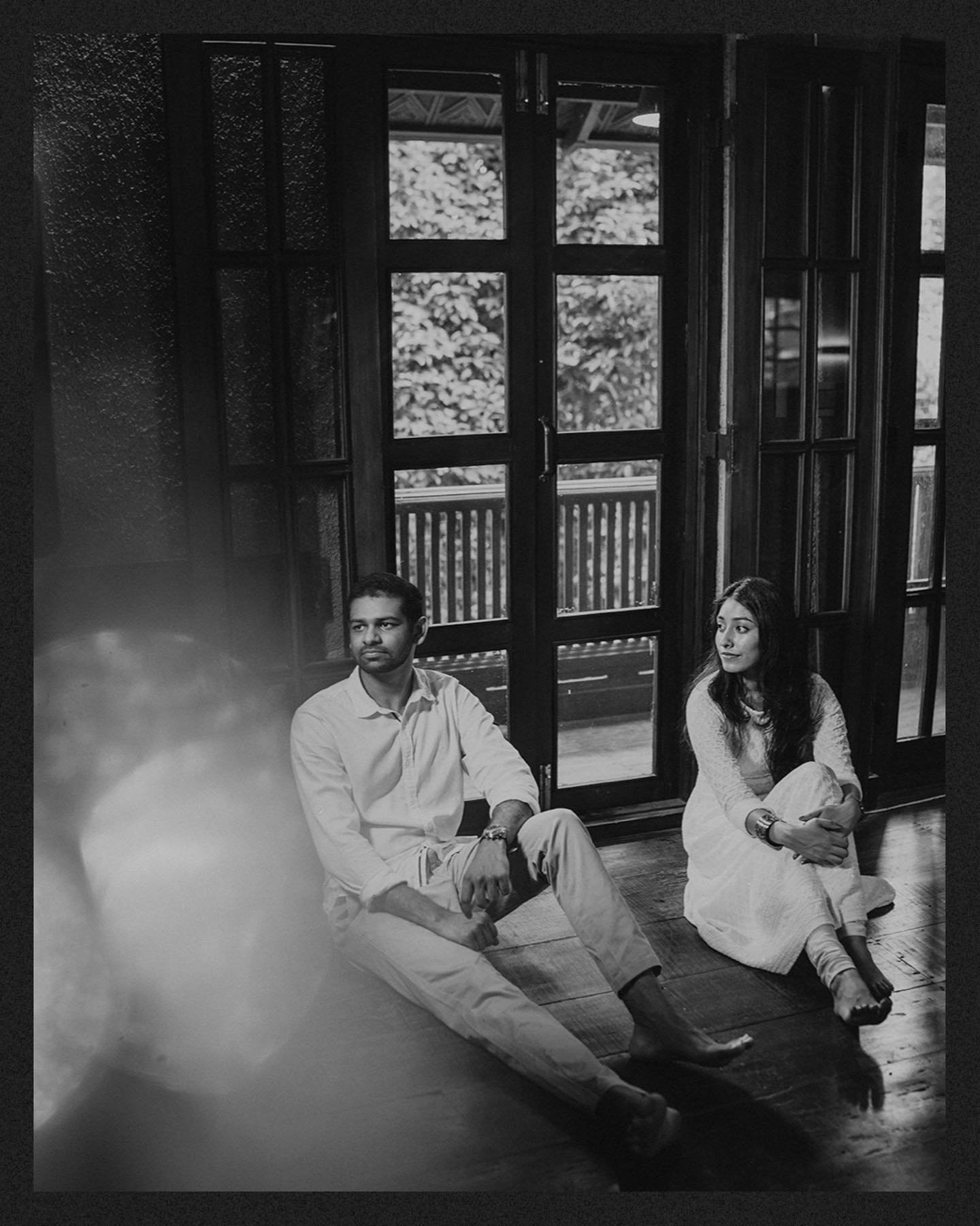 A candid black and white portrait of a couple seated together